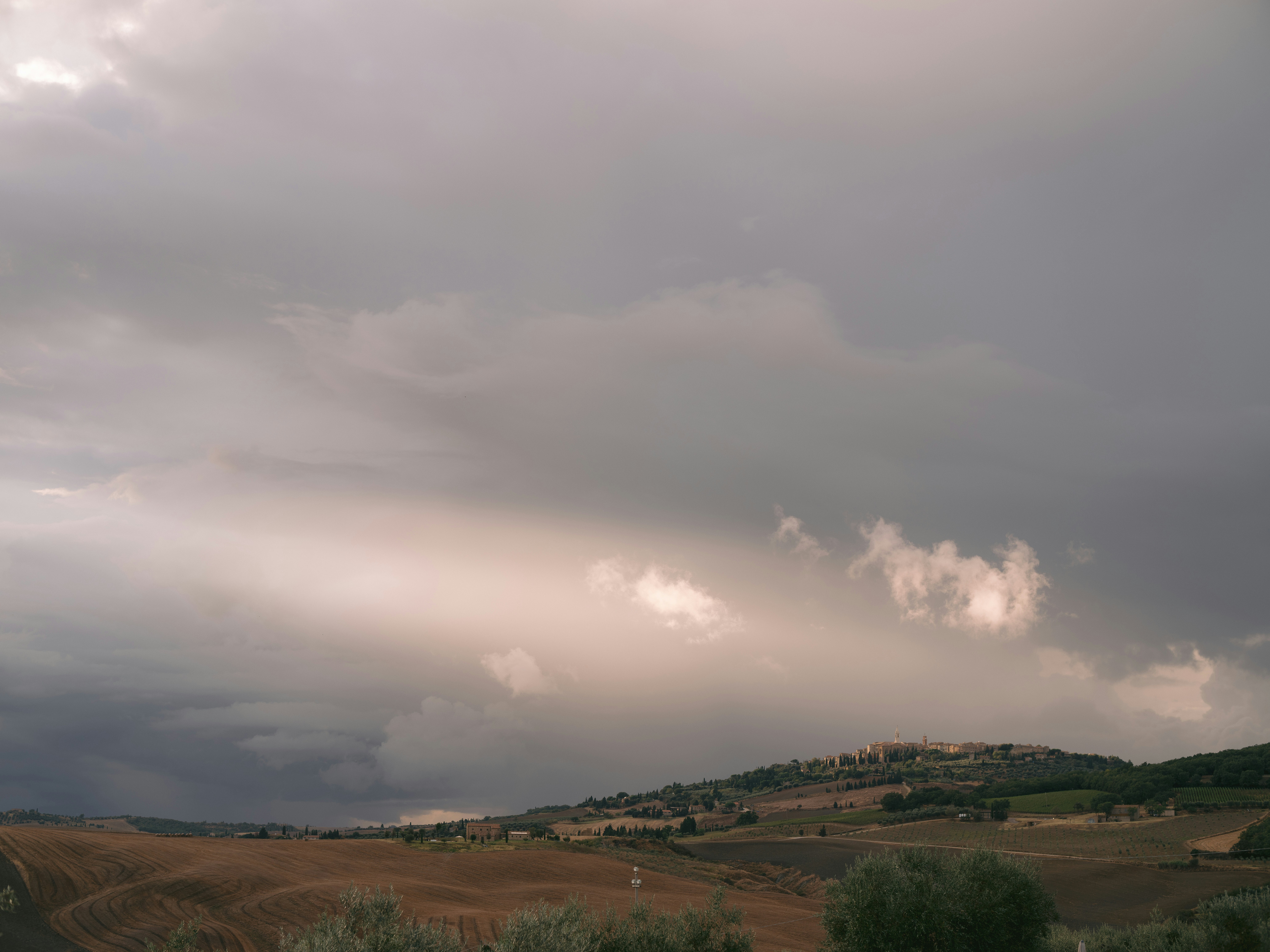 A large field with a hill in the background