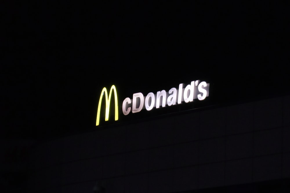 a mcdonald's sign lit up in the dark