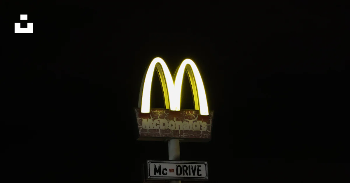 A mcdonald's sign is lit up at night photo – Free Night Image on Unsplash