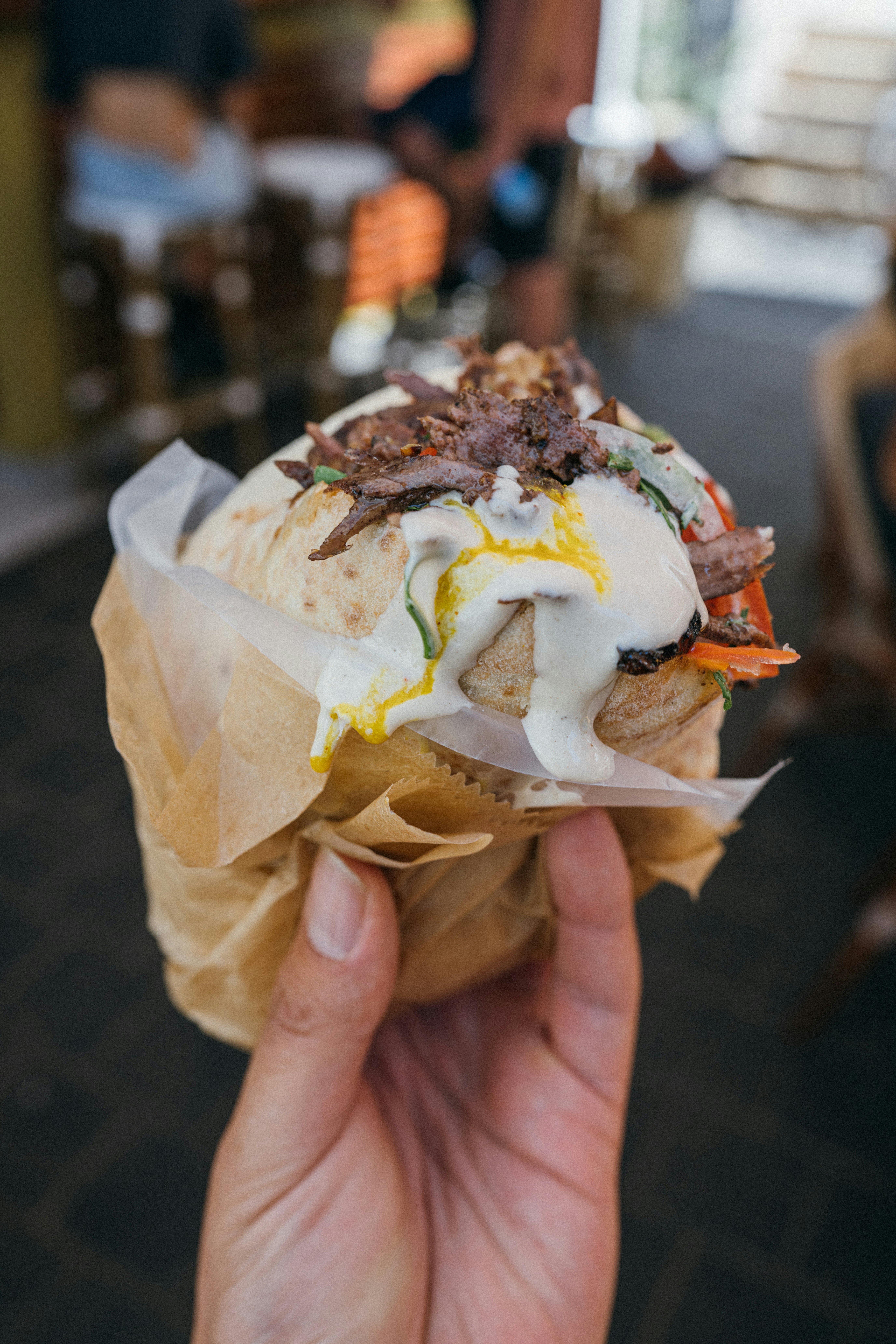 Wrapped shawarma with garlic sauce on parchment paper