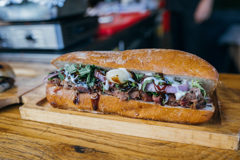 a sandwich on a cutting board on a table