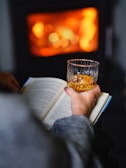 Snapshot of Cody relaxing with a book by the fireplace in the evening.