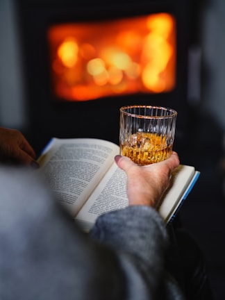 Snapshot of Cody relaxing with a book by the fireplace in the evening.