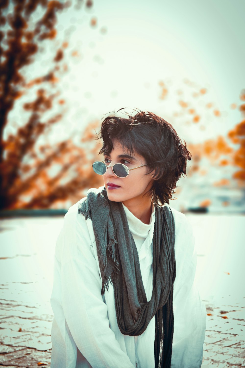 a woman with sunglasses and a scarf around her neck