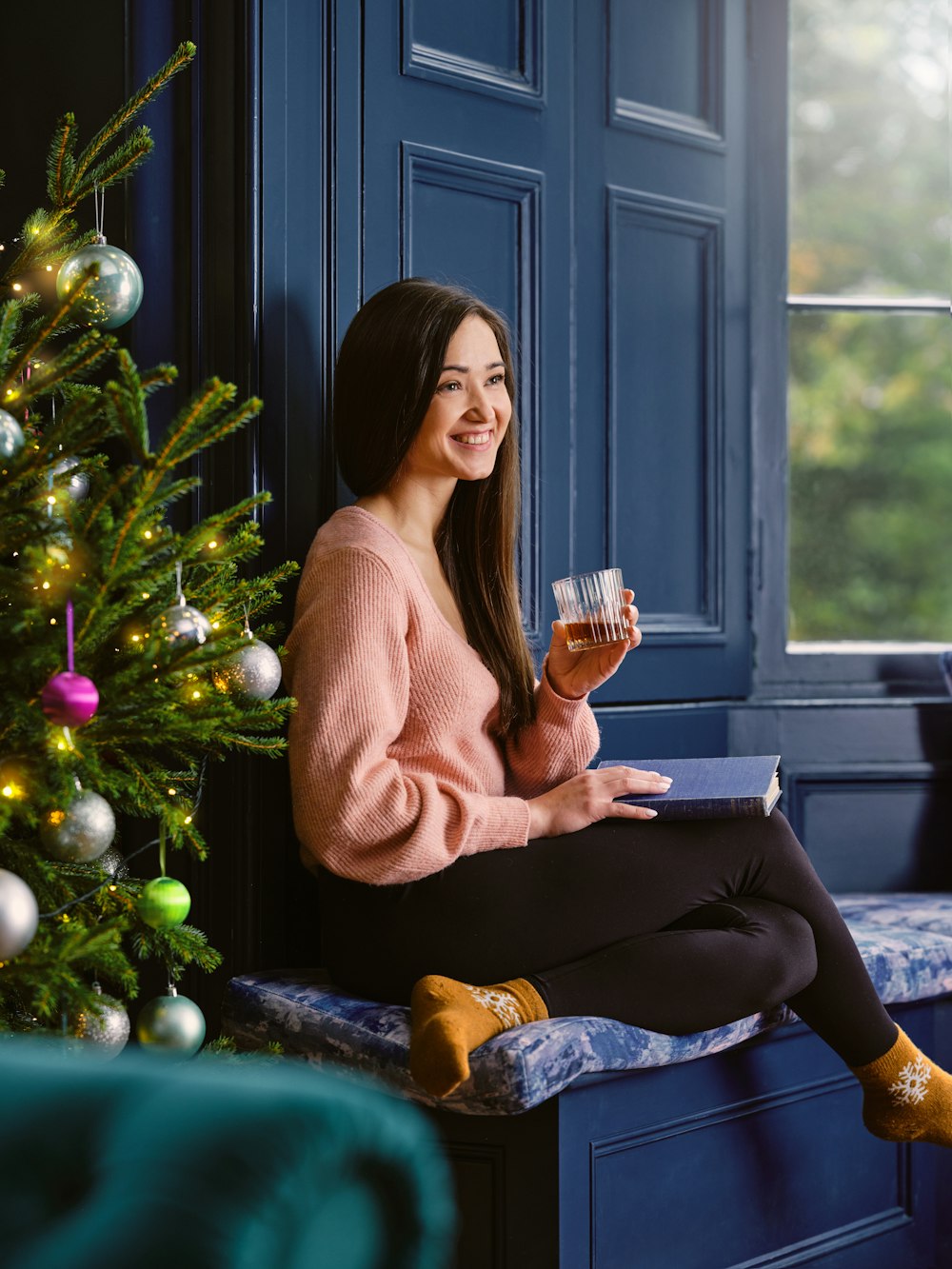 a woman sitting on a bench holding a glass of wine