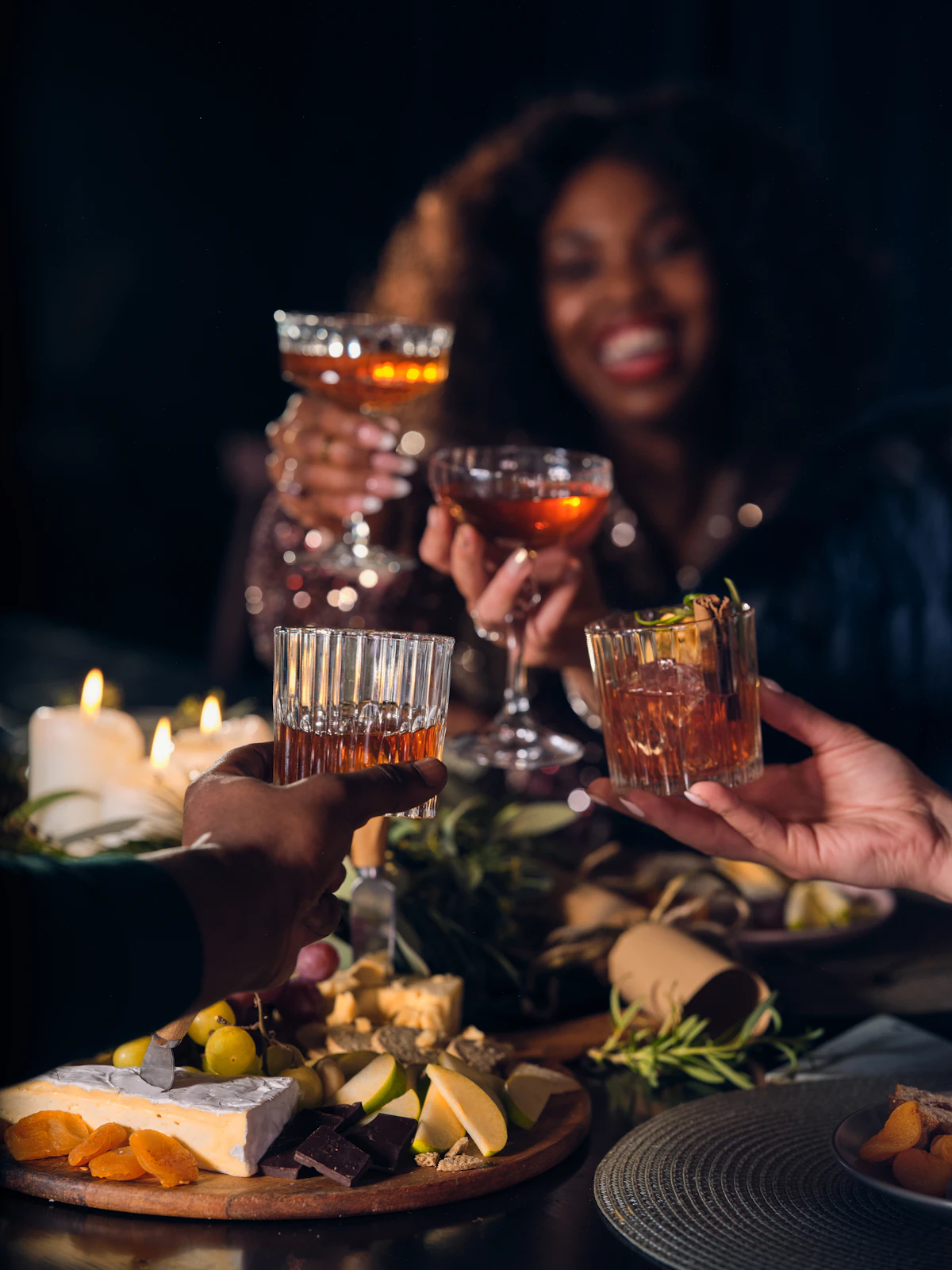 A group of friends raising their glasses in a toast around a table
