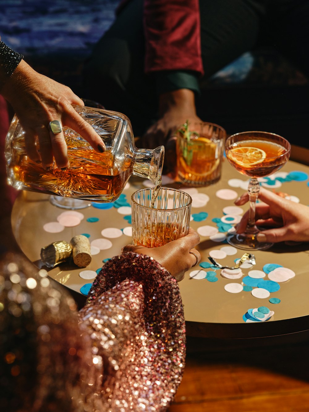 a group of people sitting around a table with drinks