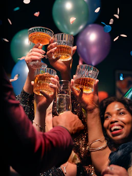 a group of people holding up glasses of wine