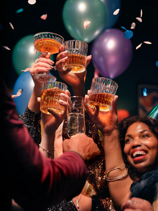 a group of people holding up glasses of wine