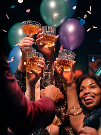 a group of people holding up glasses of wine