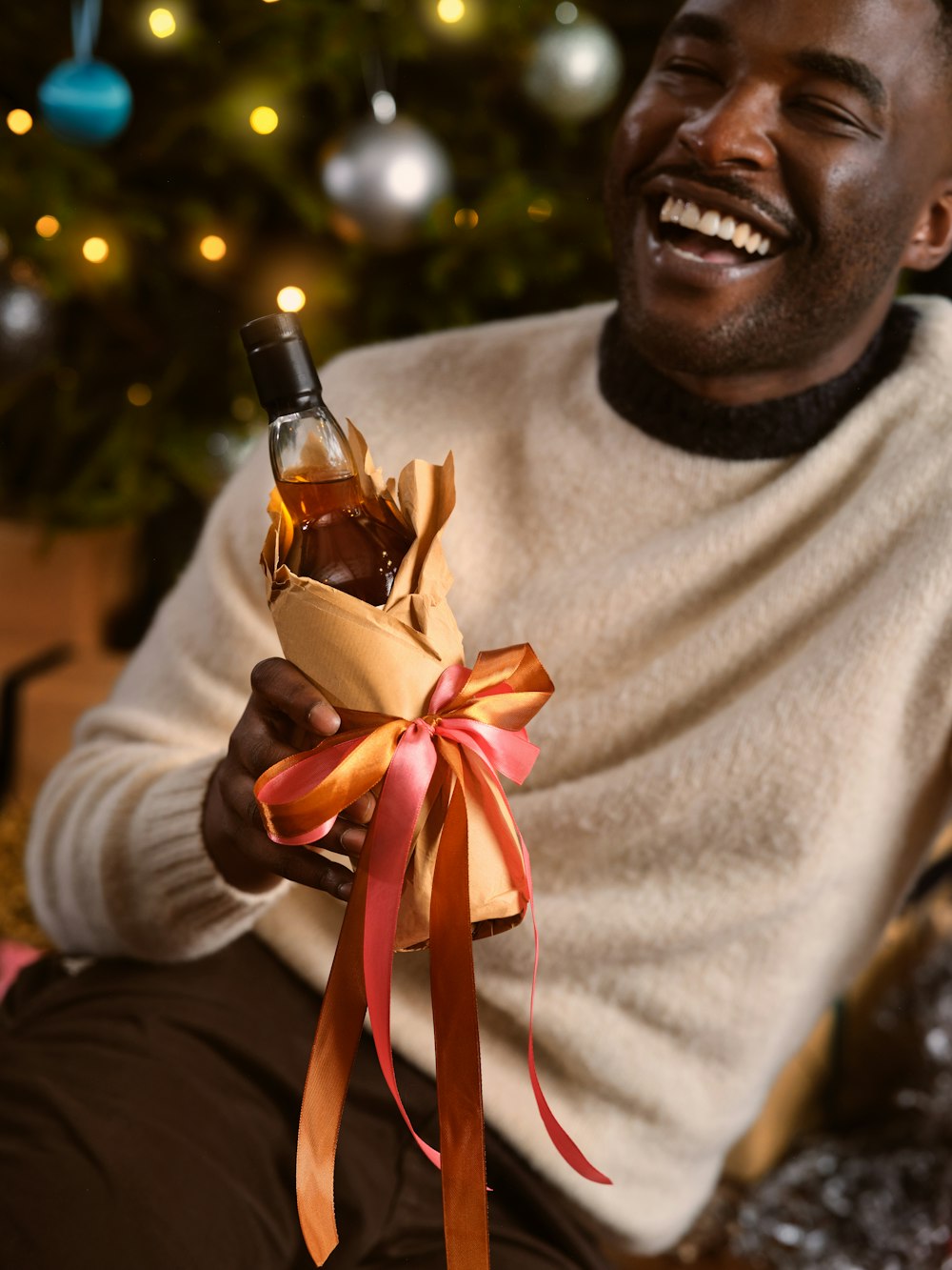 a man holding a bottle of wine in his hand