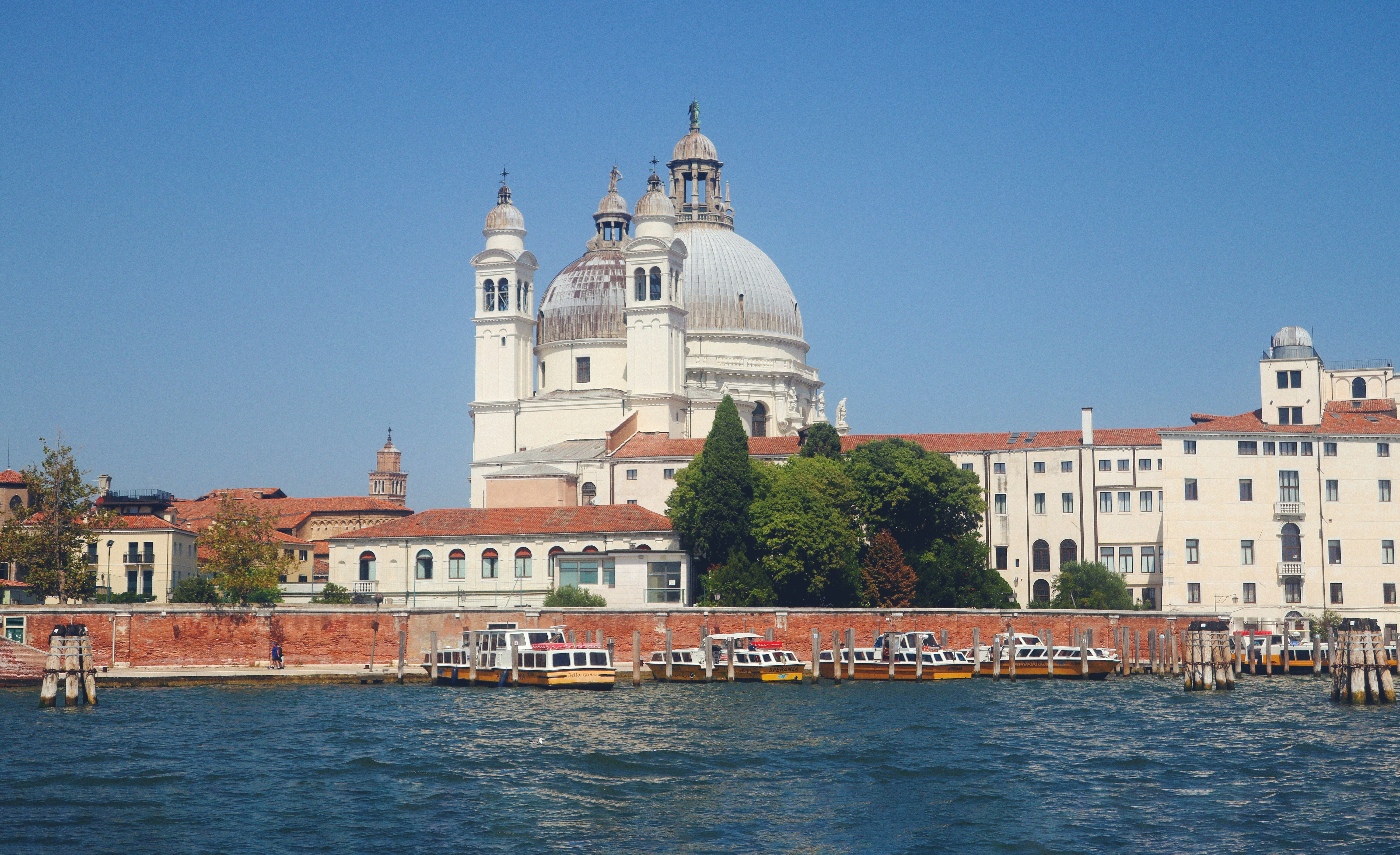 a large building with a dome on top of it next to a body of water