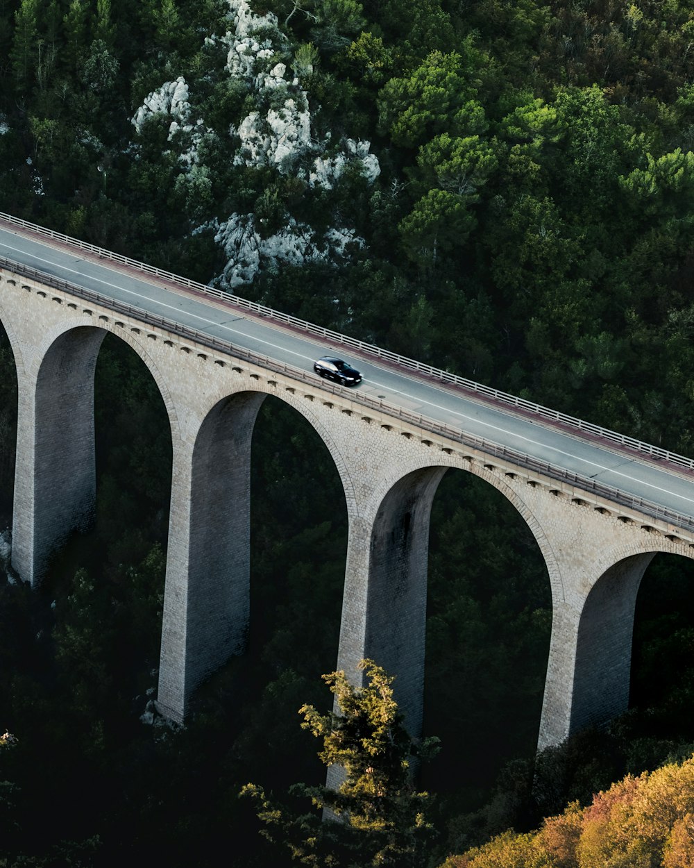 an overhead view of a bridge with a car on it