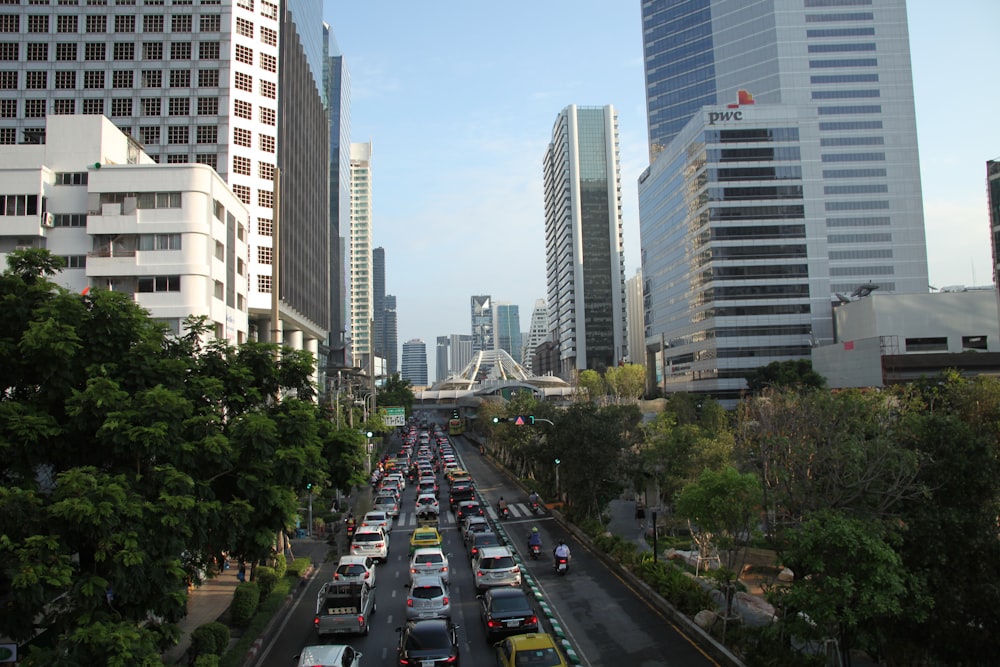 a street filled with lots of traffic next to tall buildings