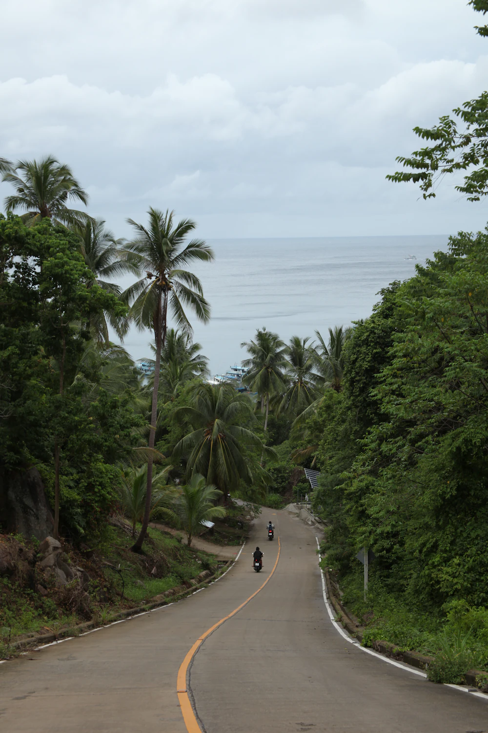 A motorbike on the coast road beside the ocean on Koh Phangan