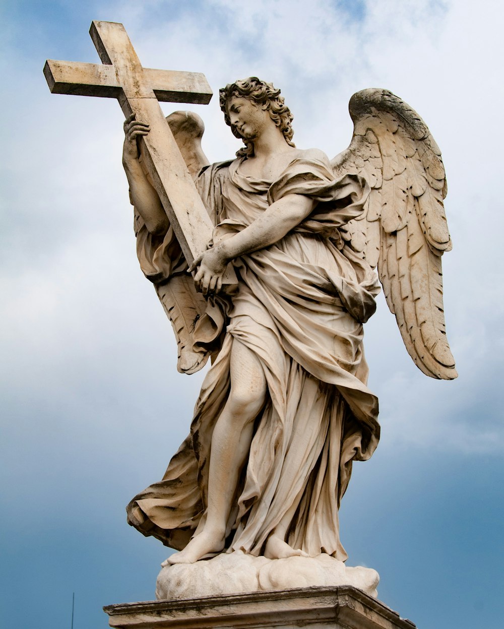 a statue of an angel holding a cross