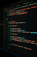 Developer coding a responsive website with security features visible.