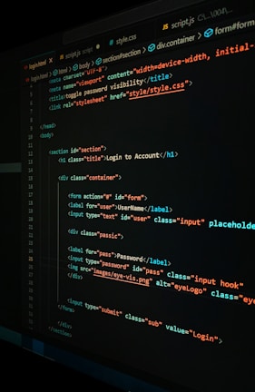 A close-up view of a computer screen displaying HTML and CSS code for a login form. The code includes elements like head, body, various input fields for username and password, and linked style sheets. The text is primarily in blue, white, orange, and green, set against a dark background.