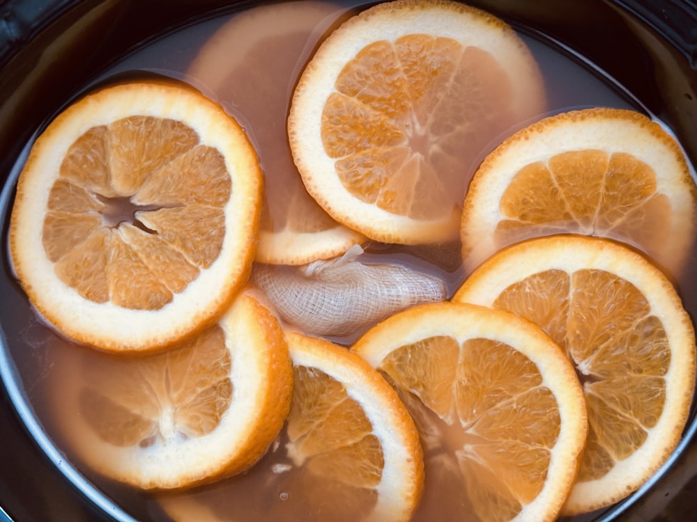 sliced oranges in a pot of water