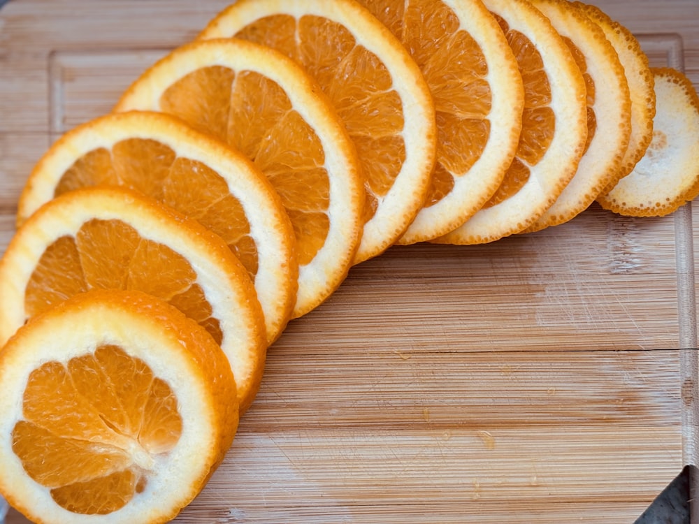 a bunch of orange slices on a cutting board