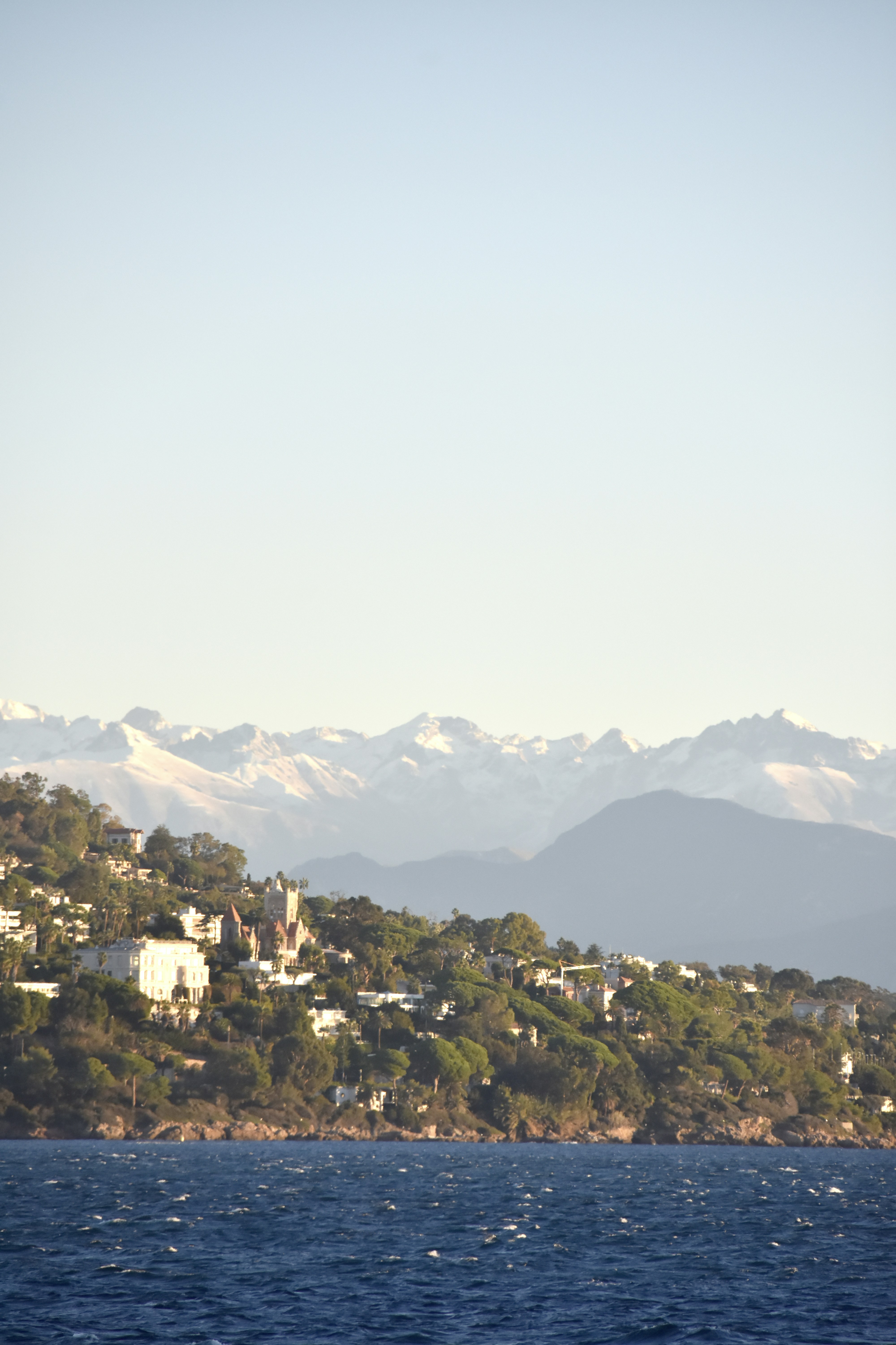 a large body of water with mountains in the background
