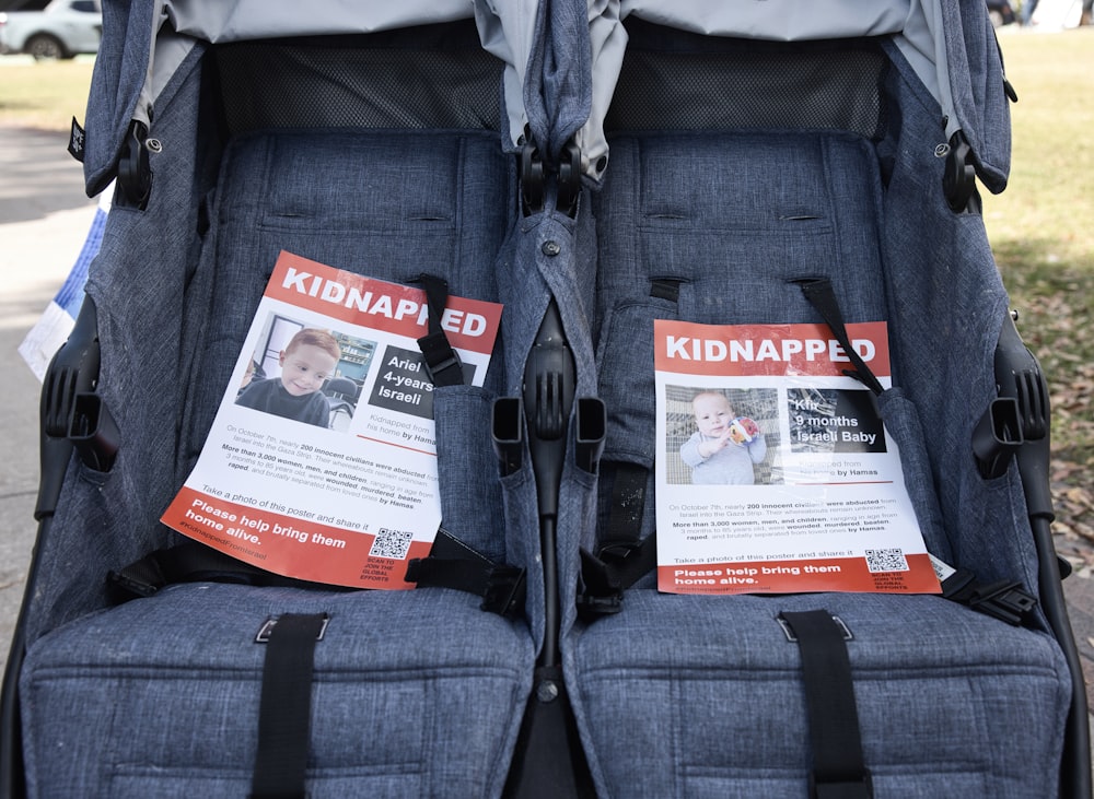 a pair of baby strollers with a kid napped sign on them