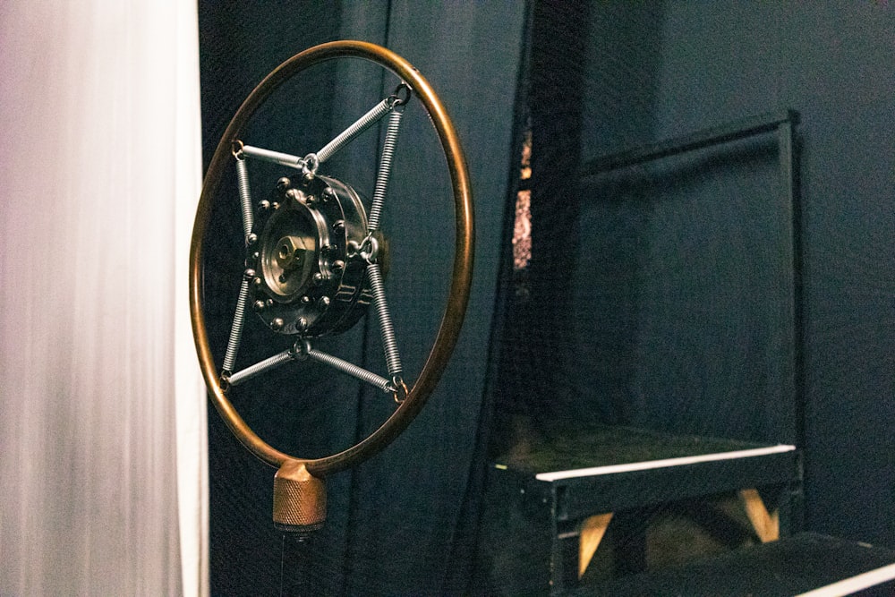 a bike wheel hanging from the side of a wall