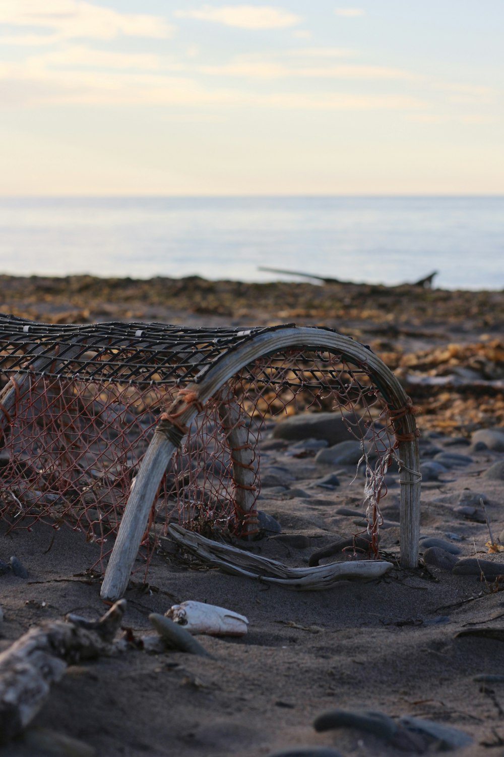 an old fishing net on the beach near the ocean
