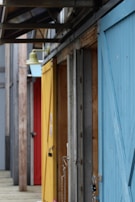 A row of colorful doors displayed in a showroom setting, illustrating variety.