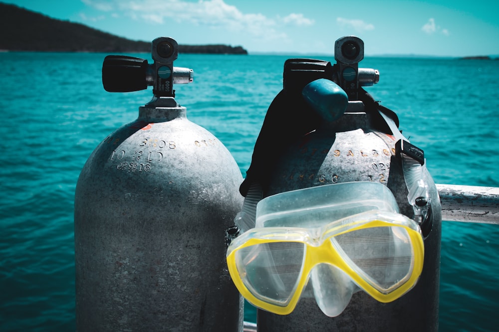 a pair of scuba goggles sitting on top of two buoys