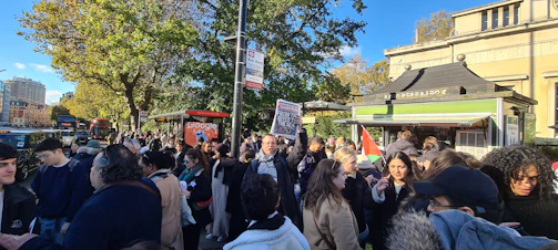 Volunteers distributing poppies during a community drive on a busy street corner.