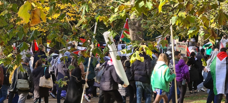A diverse group of people planting trees together under a bright sky, symbolizing unity and climate action.