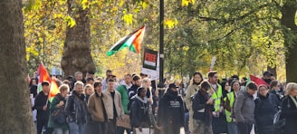 A group of diverse Ohio voters gathering signatures on a petition outdoors.