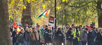 A diverse group of Winter Haven community members gathered outdoors, proudly holding 'Vote' signs in blue and red.