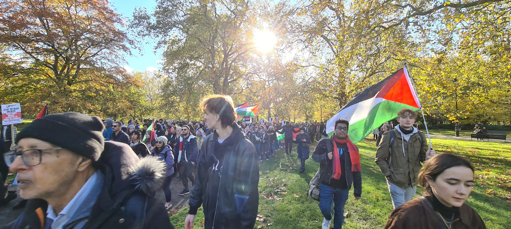 Volunteers planting trees together in a sunny park, symbolizing community effort.