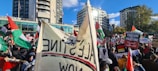 People engaging in a peaceful protest with banners and flags.