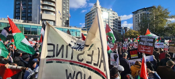 A dynamic scene of a peaceful protest with banners and diverse crowds in a city square.