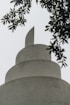 a bird sitting on top of a cement structure