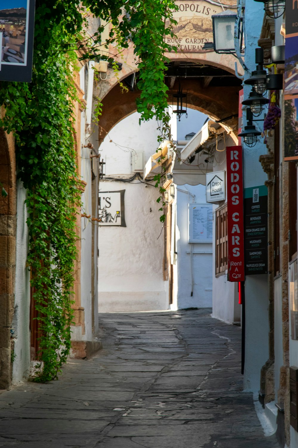 a narrow alley way with a clock on the wall