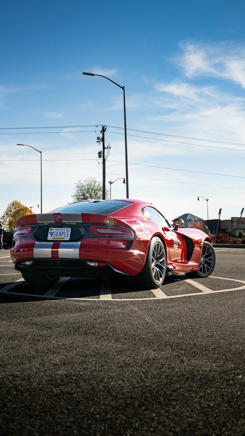 a red sports car parked in a parking lot