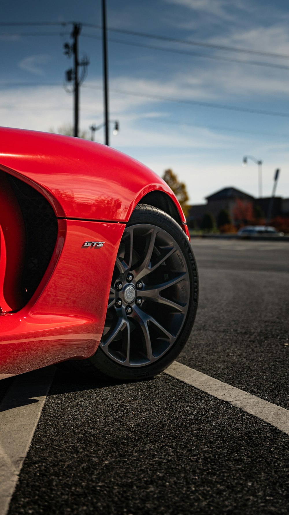 a red sports car parked in a parking lot