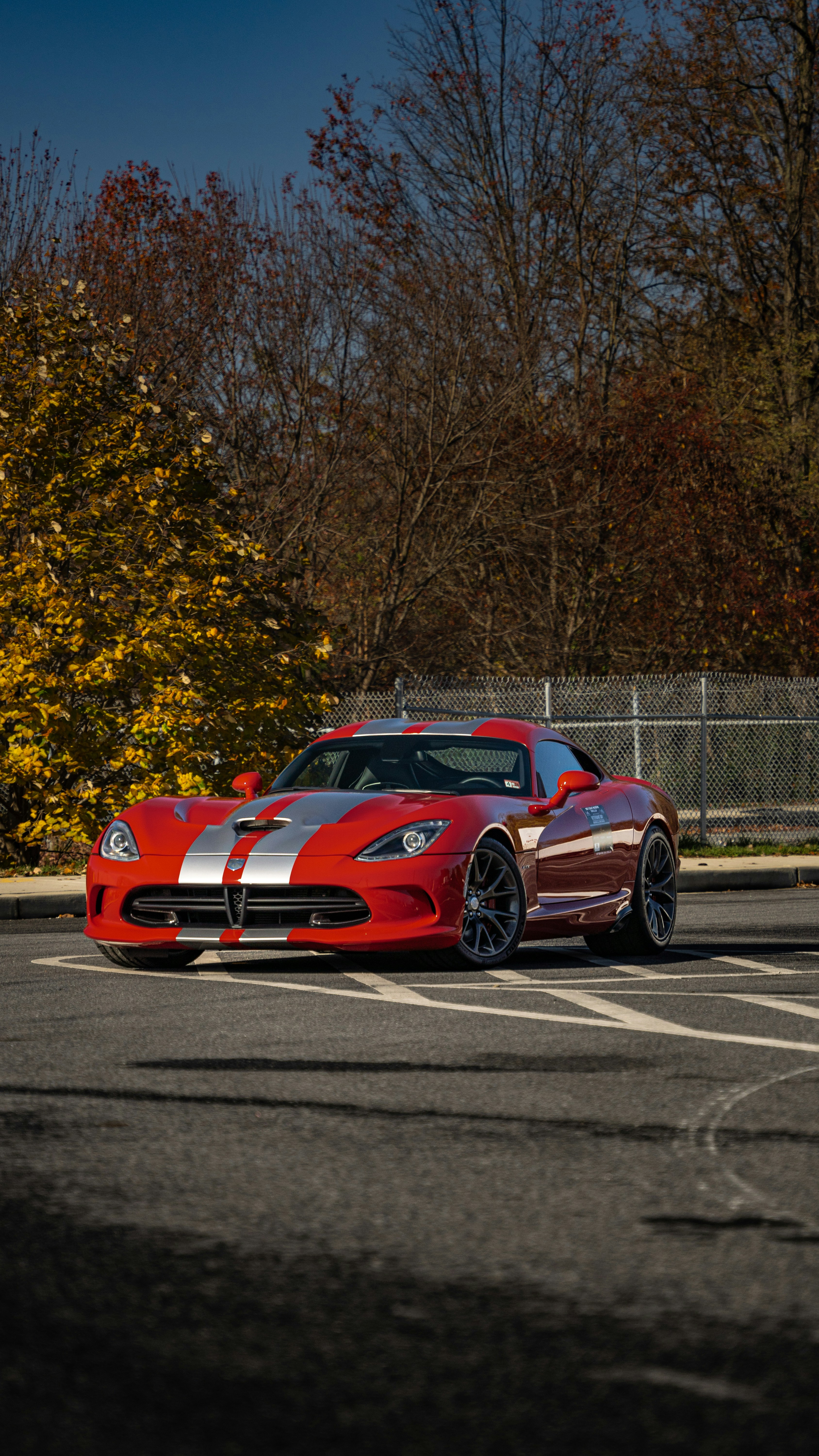 a red sports car parked in a parking lot