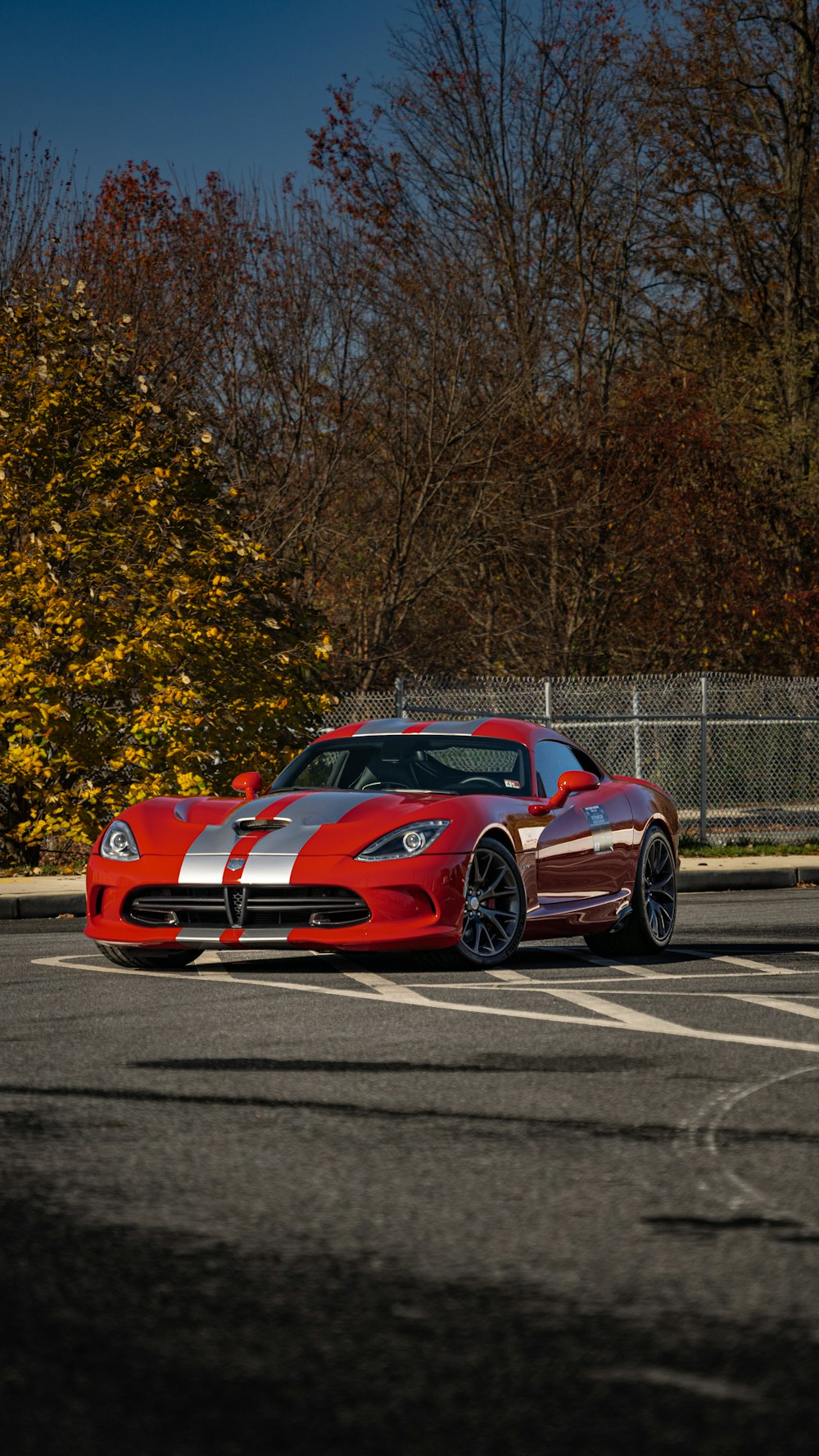 a red sports car parked in a parking lot