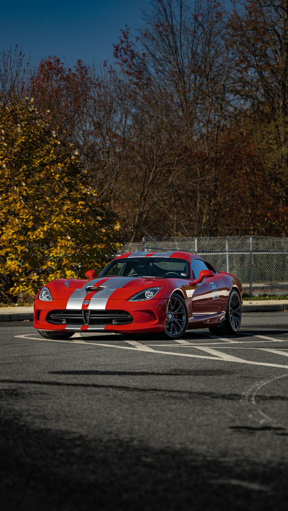 a red sports car driving down a race track