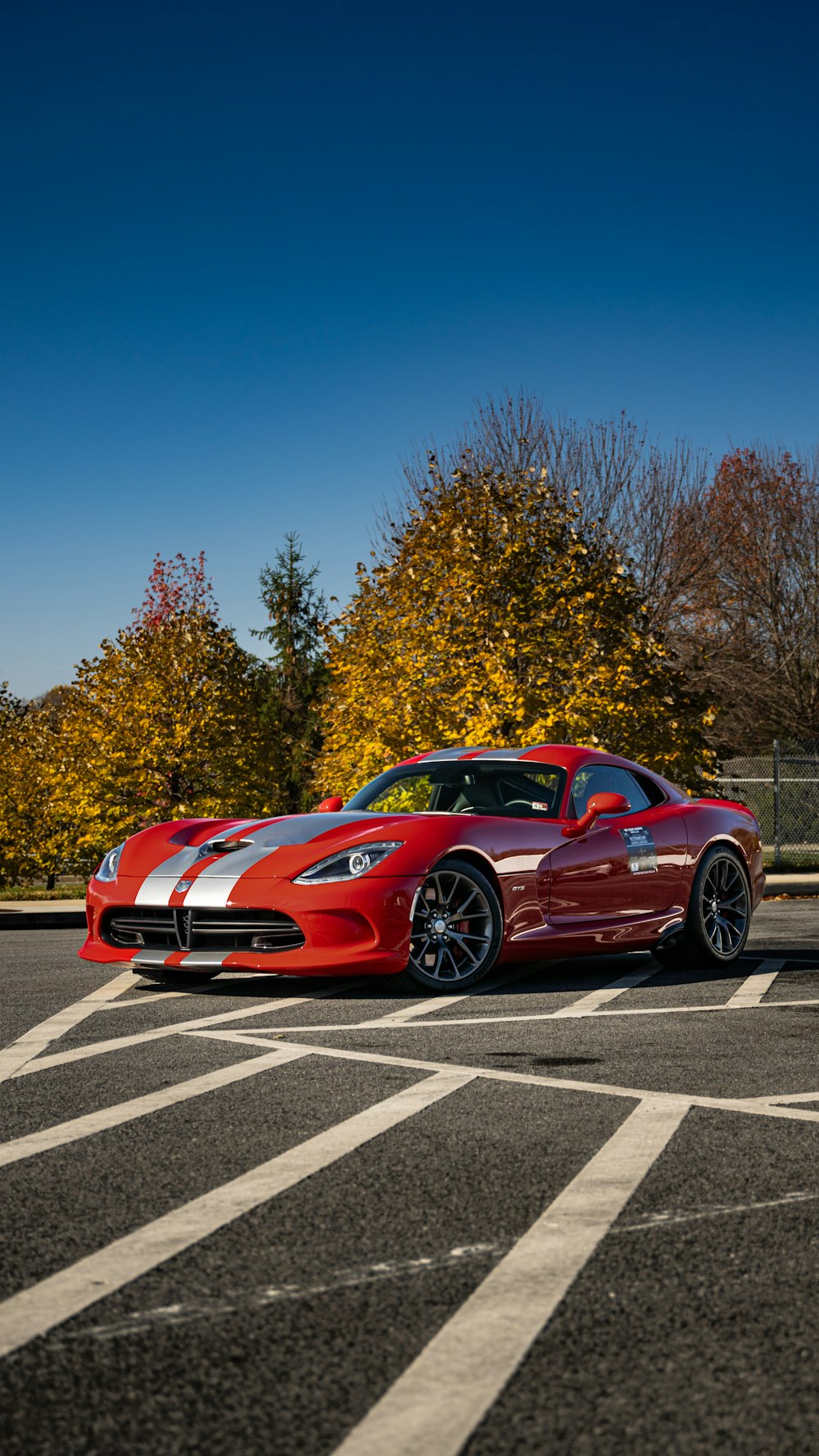 a red sports car parked in a parking lot