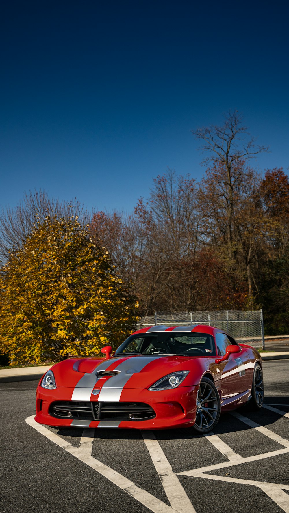 a red sports car parked in a parking lot