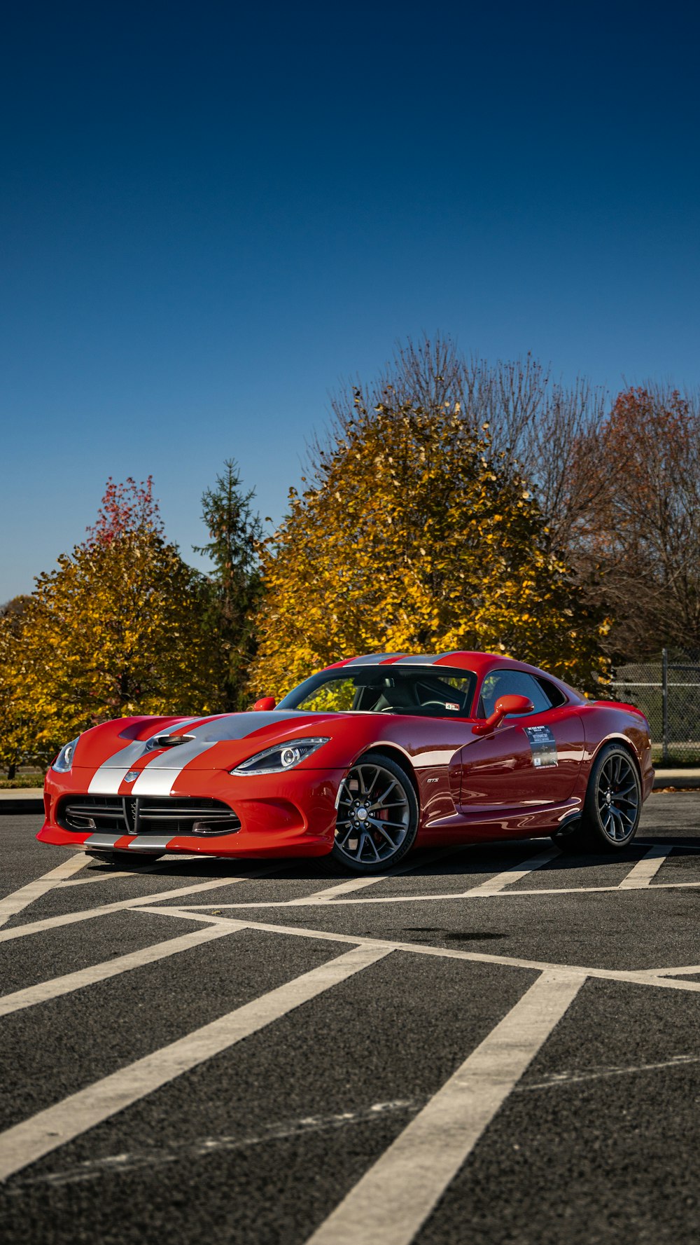 a red sports car parked in a parking lot