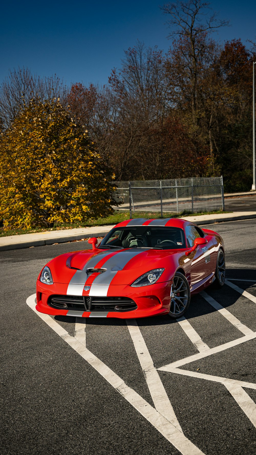 a red sports car parked in a parking lot