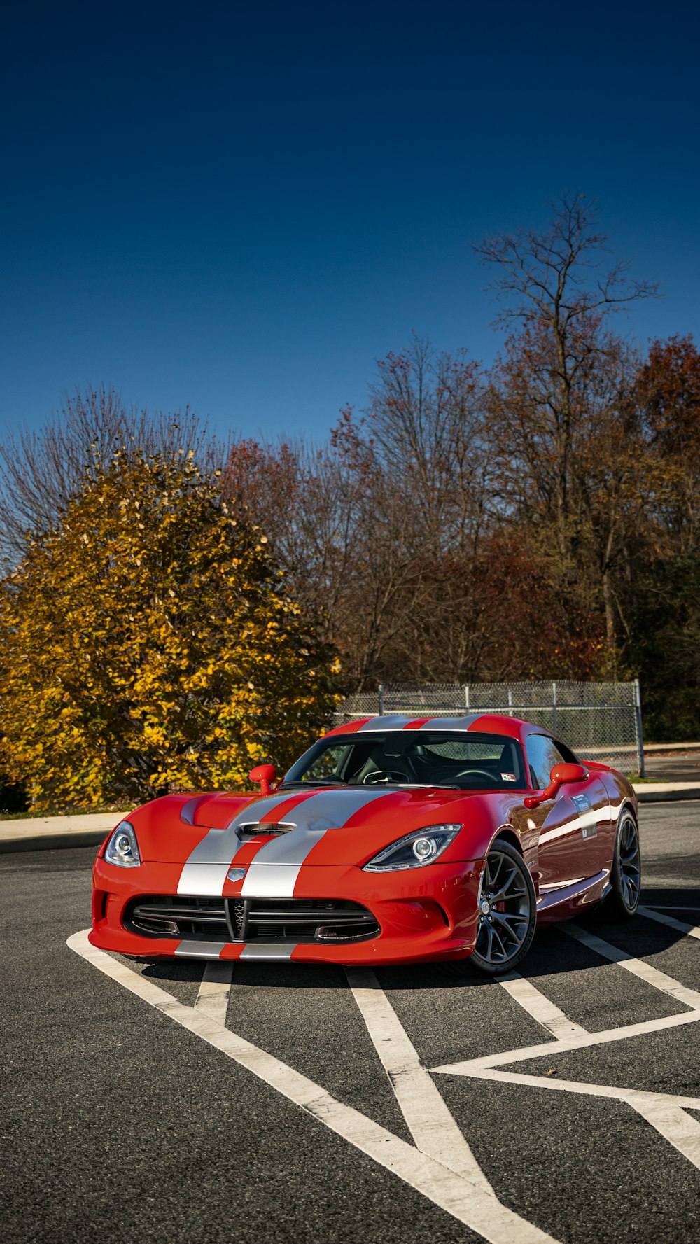 a red sports car parked in a parking lot