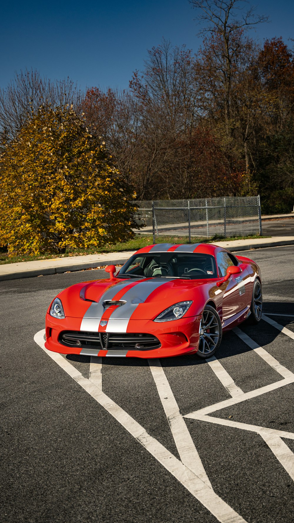 a red sports car parked in a parking lot